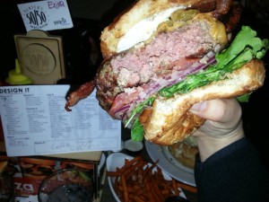 Slaters 5050 Customer Burger in hand eaten