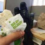 Taco Bell DoorDash Tom eating at desk with feet up